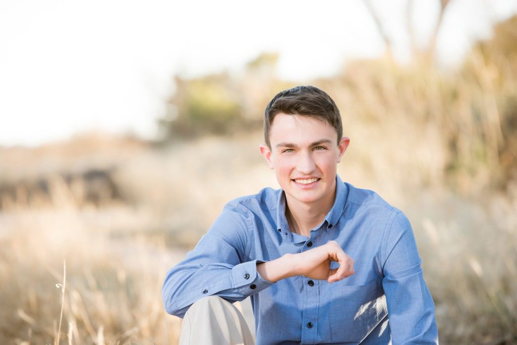 high-school-senior-boy-in-tall-yellow-grass