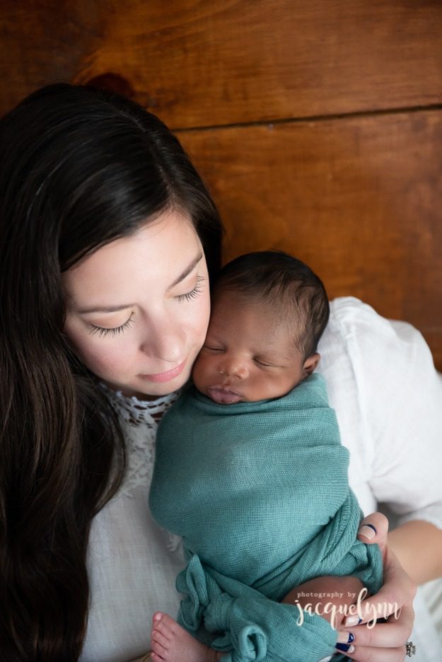 mom cheek to cheek with her newborn son