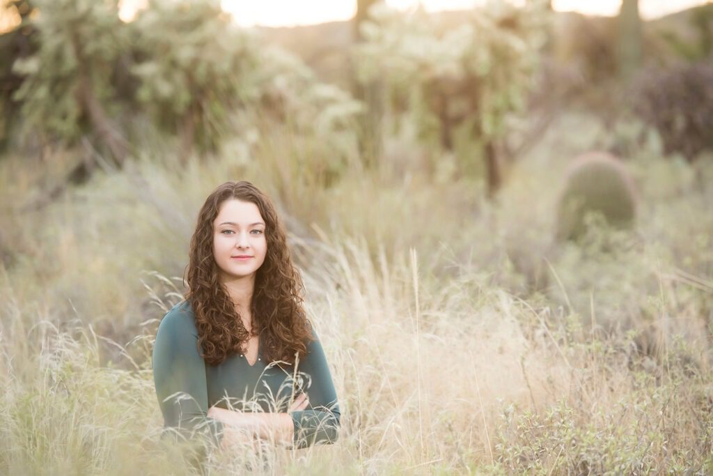 girl in grass wearing green