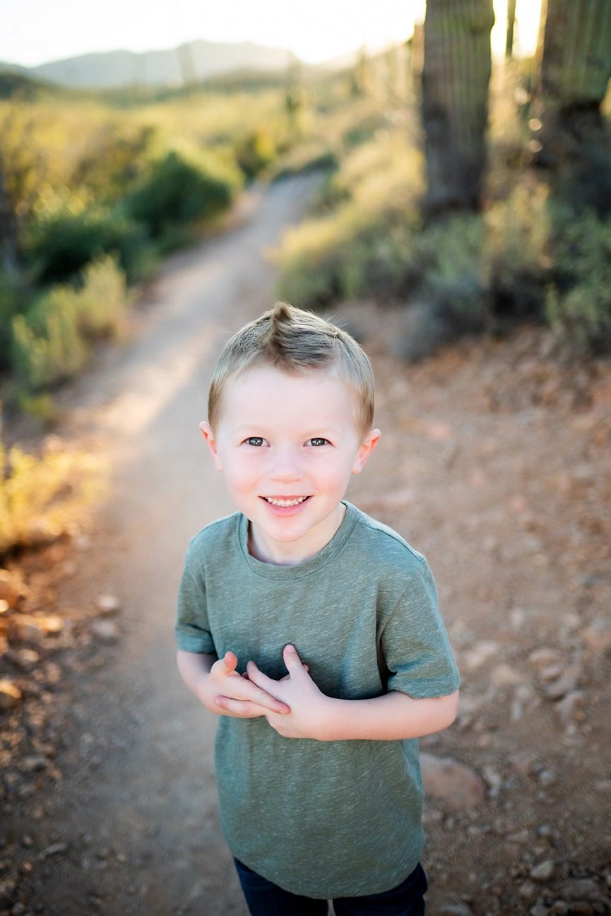 boy wearing green with saguaro cactus